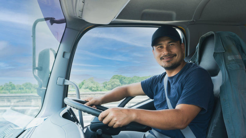 truck driver bearded man smiling fasten seat belt.