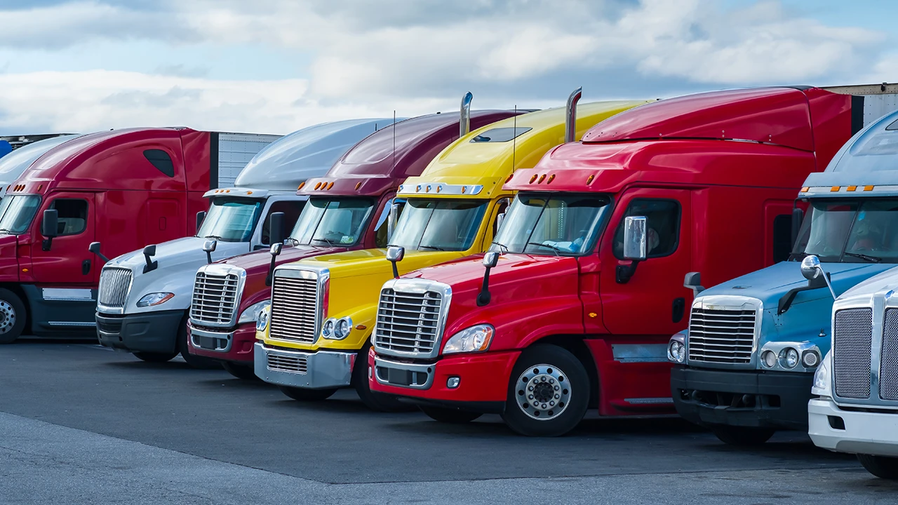 group of semitrucks parked next to each other