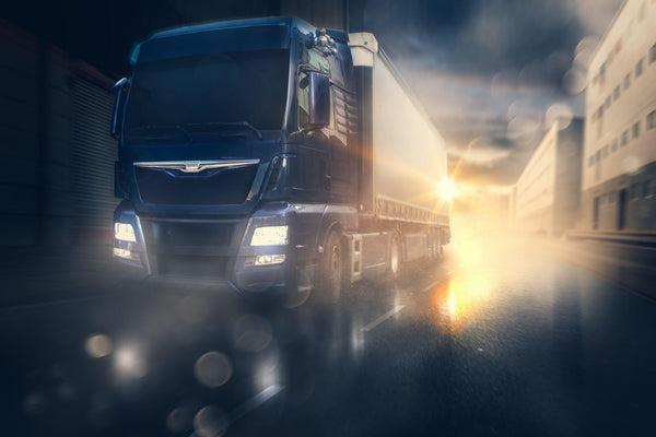 A semi truck driving in rainy conditions