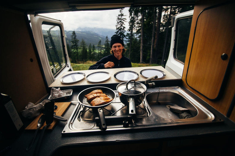 Happy man in a converted camper van