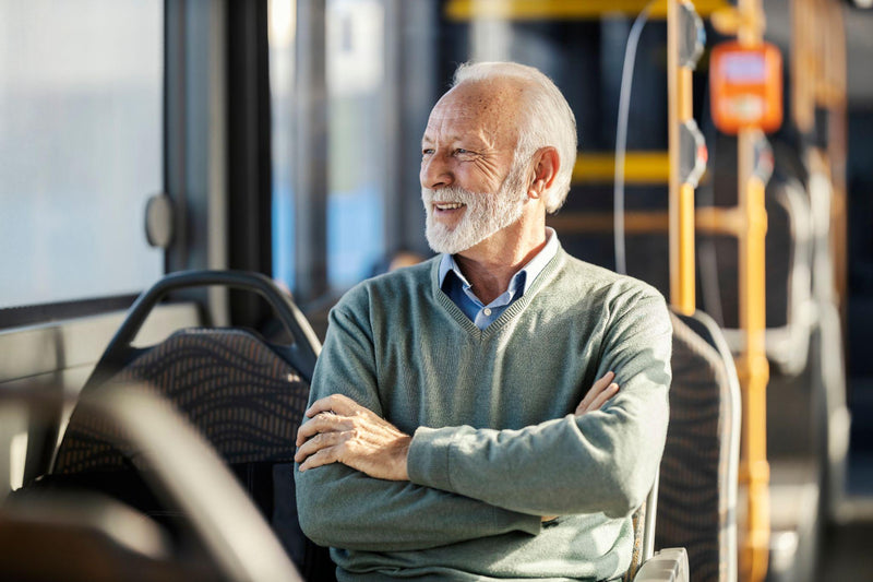 Man sitting in an old bus seat