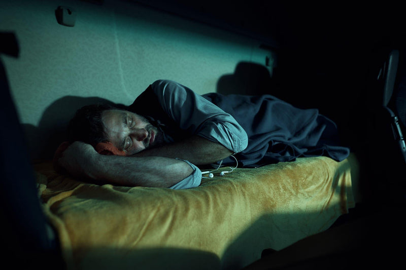 Semi truck driver sleeping in truck