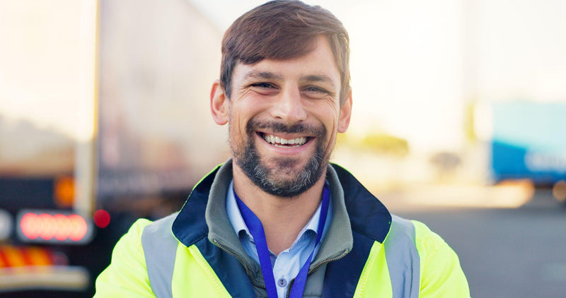 Smiling truck driver who is happy with his employer