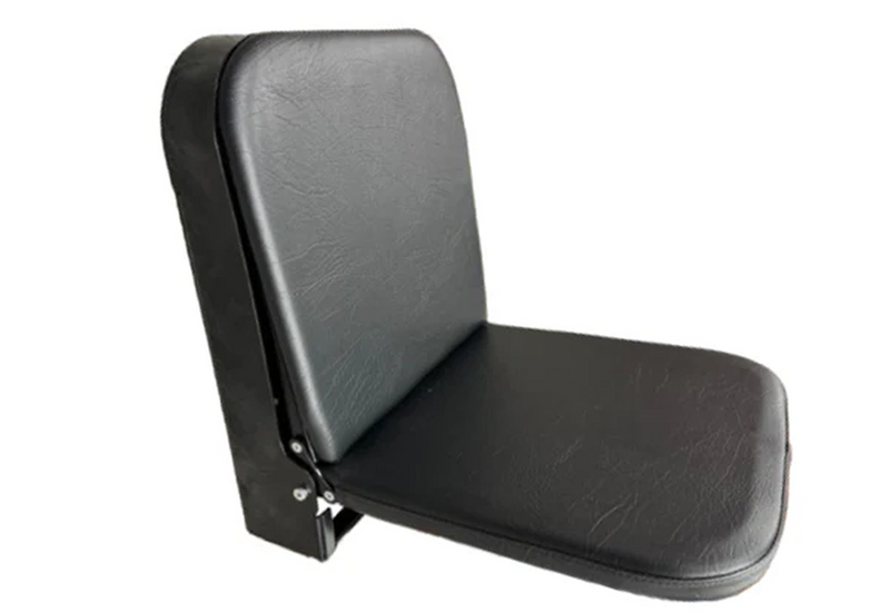 A simple black padded folding seat with a backrest, shown in profile. It appears minimalistic and functional, designed for compact spaces.